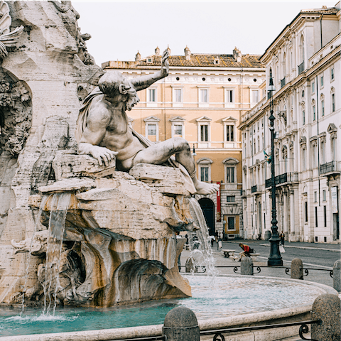 Admire the Fontana del Nettuno, a four-minute walk from your apartment