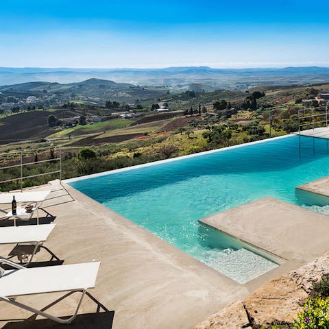 Step into the infinity pool and soak up Sicilian countryside views