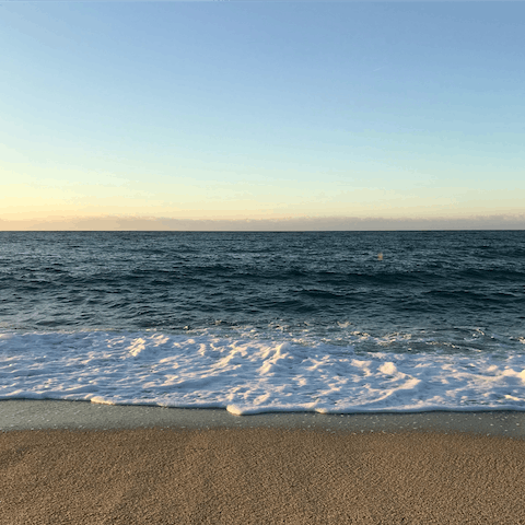 Stroll to Delfino Beach, where a seaside bar and restaurants await