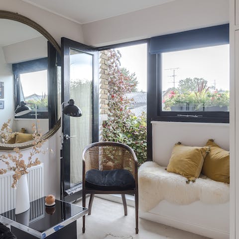 Make yourself comfortable in the bedroom's boudoir-style lounge area with access to a balcony