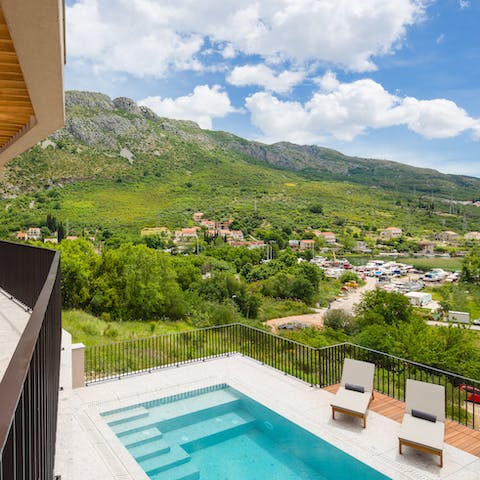 Plunge into the pool overlooking the valley