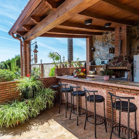 Pull up a chair and watch the chef of the group grill up a storm in the outdoor kitchen