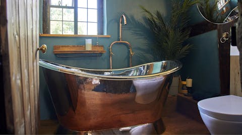 Relax in the gorgeous copper bathtub surrounded by plants and unique features