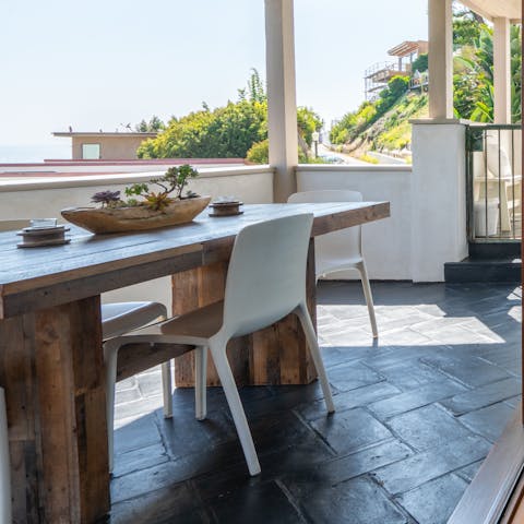 Eat outdoors at the chunky wooden table