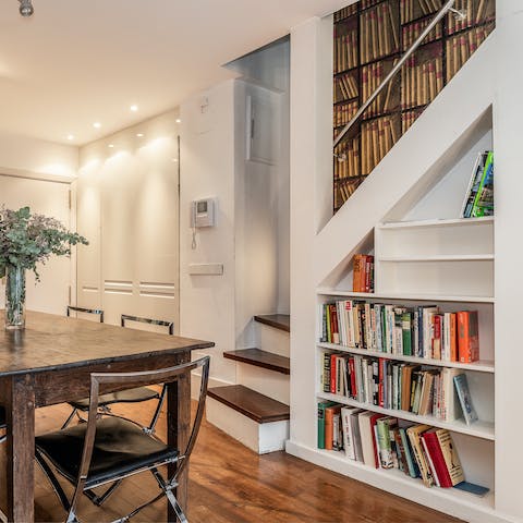 Delve into a book from the bookshelf under the stairs