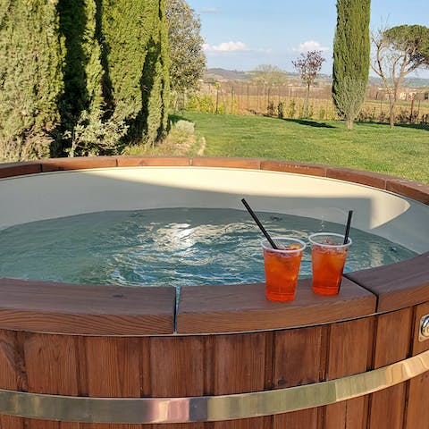 Sink into the bubbling Finnish hot tub, sipping on a cocktail, looking out to the vast hills and fields
