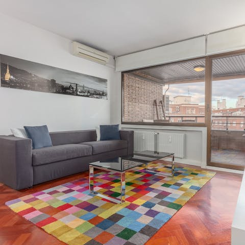 Kick back in the bright living room with a glass of Spanish wine after a day of exploring