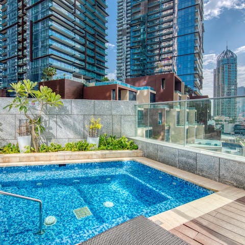 Soak in the jacuzzi while looking out at the skyscrapers and the marina