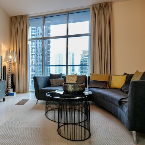 Enjoy a cityscape panorama from floor-to-ceiling windows in the living room