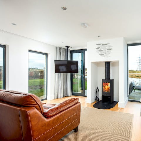 Cosy up by the living room's fire on cooler evenings