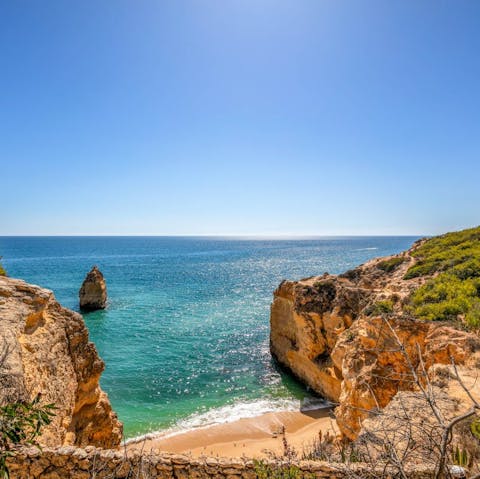 Stroll along the direct path to Praia da Marinha for a day at the beach