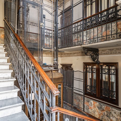 Hop on the beautiful period lift – one of the oldest in Milan.