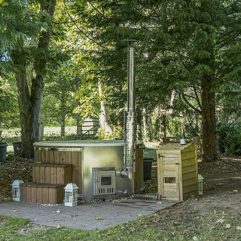 Heat up your private wood-fired hot tub in your section of the pretty garden