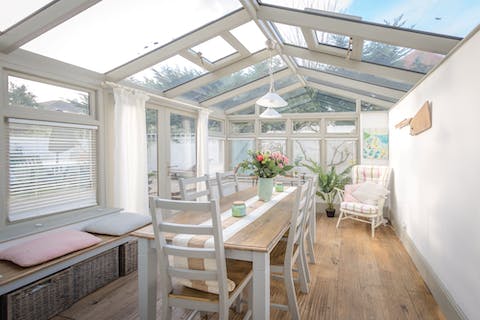 Soak up the sunshine from the glass-roofed dining conservatory