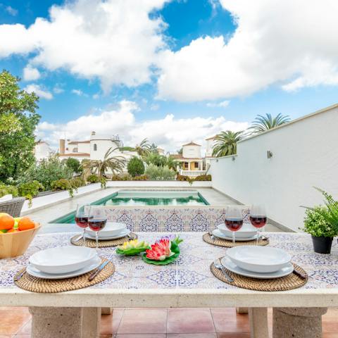 Enjoy meals at the elegant stone table by the pool