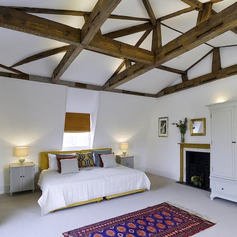 Wake up under high, wood-beamed ceilings in the spacious bedroom