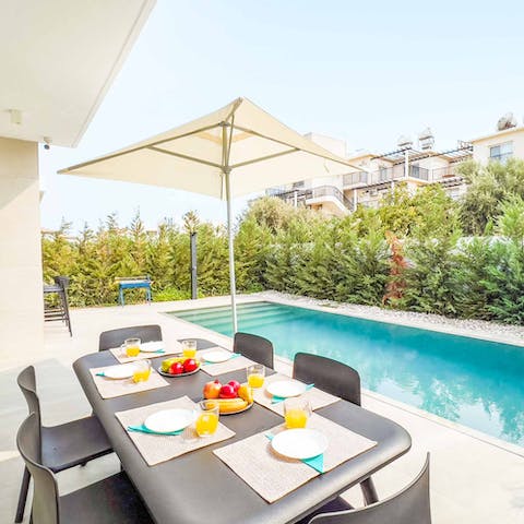 Enjoy an alfresco meal with loved ones beside the private pool
