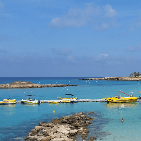 Dip your feet into the calm waters at Fig Tree Bay beach