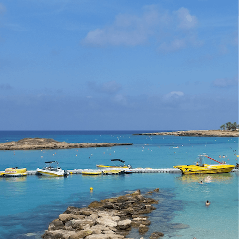 Dip your feet into the calm waters at Fig Tree Bay beach