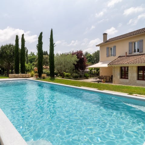 Lounge by the private pool in the expansive garden filled with greenery