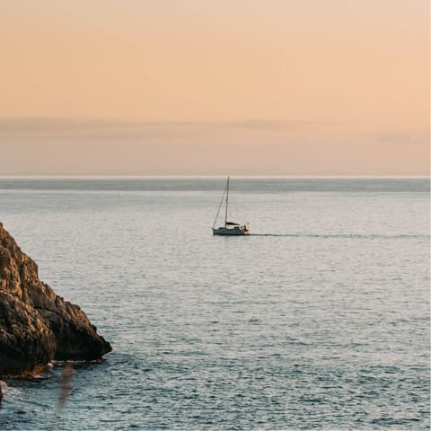 Take a boat trip along the coast and explore the island's beautiful coves