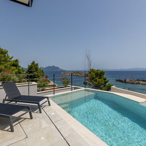 Lie back by the pool and soak up the sun and sea views