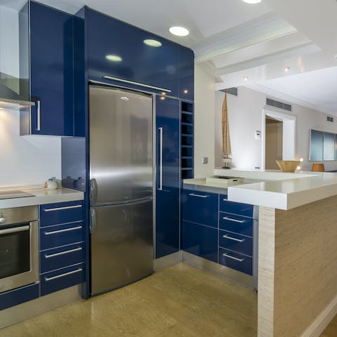 Cook a delicious dinner in your bold blue kitchen for a quiet evening at home