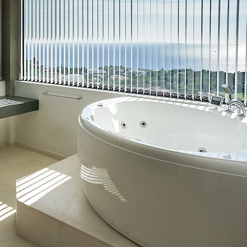 Soak in the jetted bathtub overlooking the Mediterranean