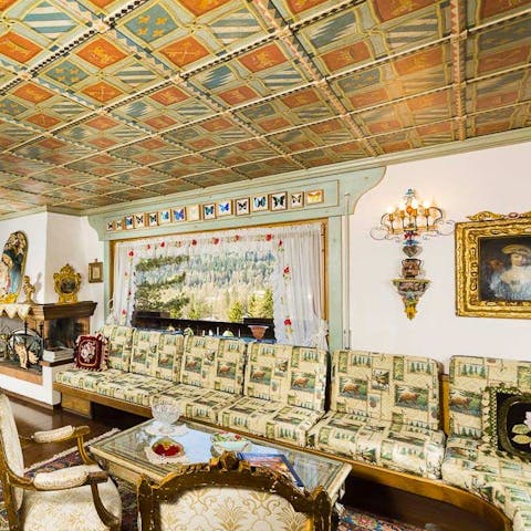 The painted ceiling and bold upholstery on the sofa