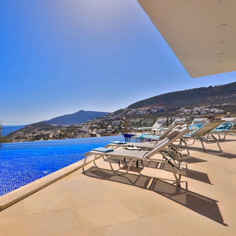 Laze around the private swimming pool with a view of the Mediterranean Sea