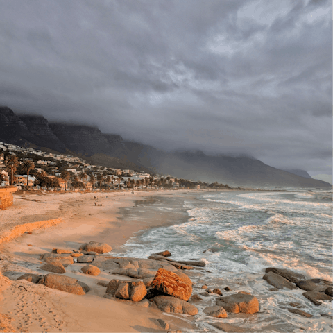 Stroll along the golden beaches of Camps Bay, just a short drive from your doorstep