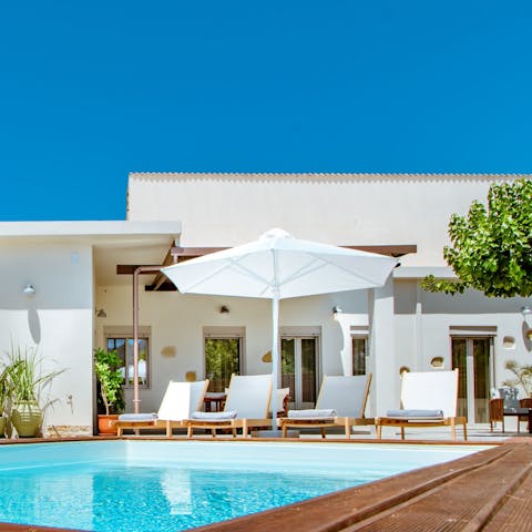 Savour refreshing dips in the pool and total relaxation on a sun lounger 
