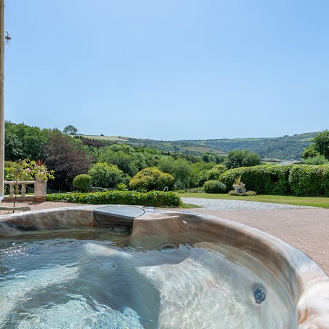 Enjoy a rejuvinating soak in the hot tub overlooking the rolling hills
