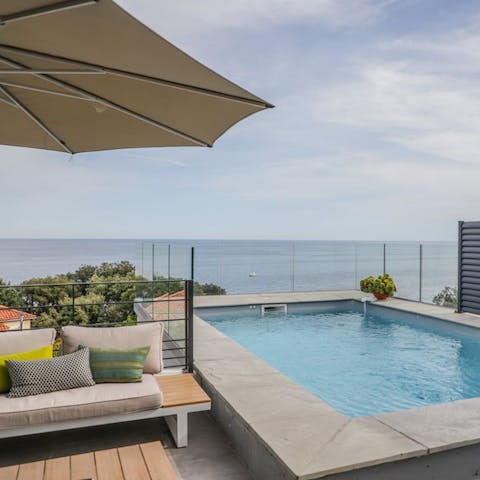 Lounge by or cool off in your private sea view pool