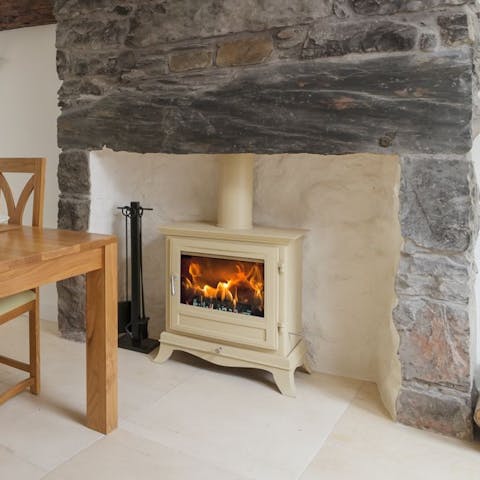 Put a log on the fire to make the living area feel extra cosy and dine in front of the flames