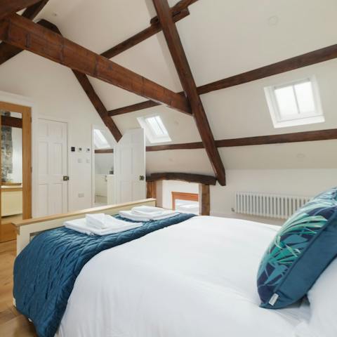 Sleep like royalty in the main bedroom, home to exposed beams and original masonry 