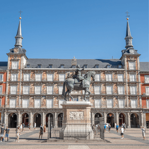 Stroll around the Plaza Mayor before people watching from a cafe