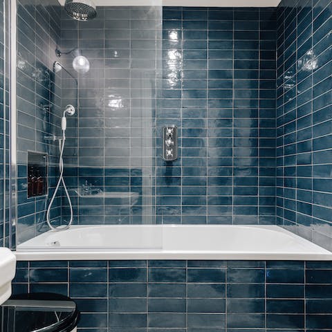 Treat yourself to a long soak in the blue tiled tub