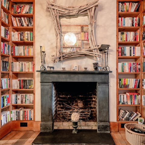 Choose a book to delve into from the extensive home library 