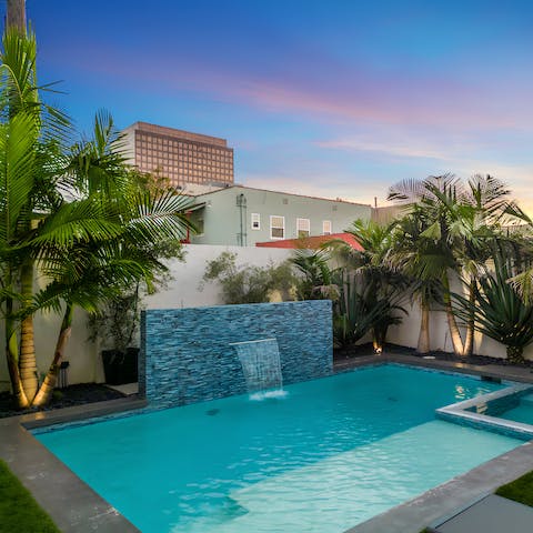 Take a refreshing dip in the palm tree-lined swimming pool