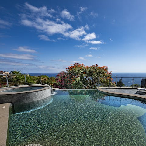 Take a dip in the glimmering swimming pool with spectacular sea views everywhere you look