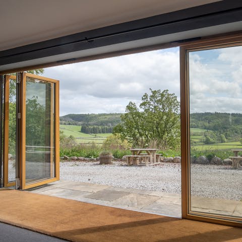 Slide open the wall of bi-folding doors to bring the outdoors in