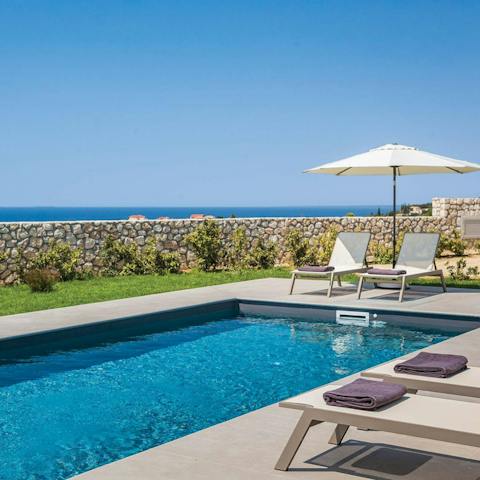Relax by the pool with its sea views