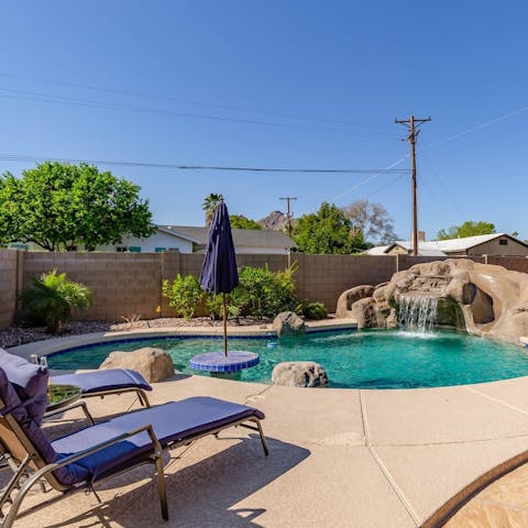 Soak up the sun by your private pool with a waterfall