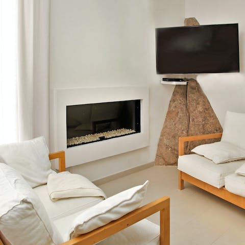 Get cosy by the electric fireplace in the living room