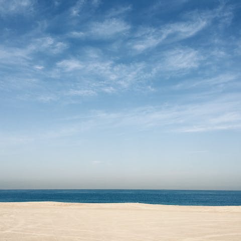 Sink your toes into the soft sand of Marina Beach