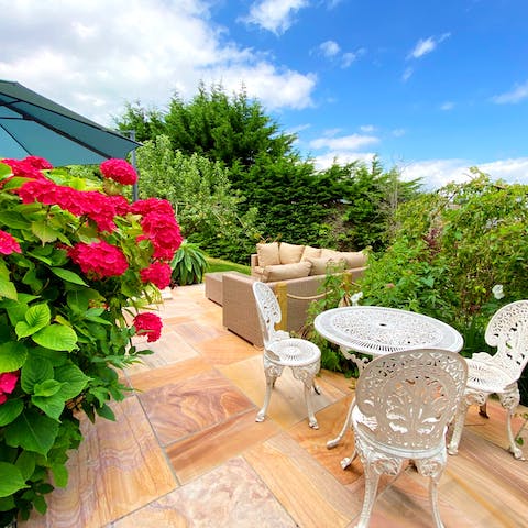 Sit out and enjoy the sunshine in the well-maintained garden