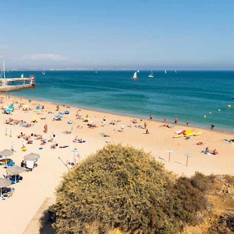 Sunbathe on Meia Praia beach, ten minutes away on foot