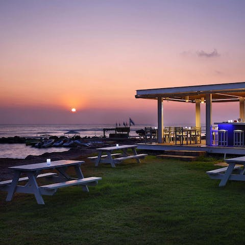 Enjoy a drink by the sea in the communal garden