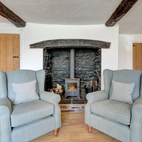Cosy up in an armchair by the fire